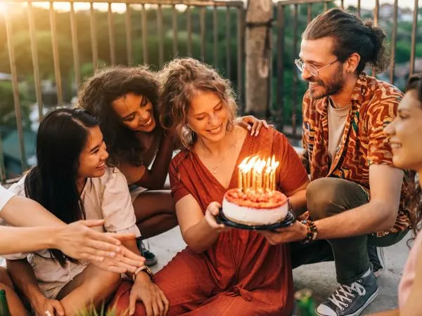 Warm birthday celebration with glowing candles and cake creating a heartfelt emotional moment